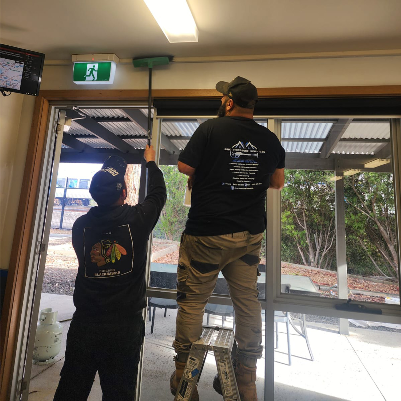 Pro Pressure Services team working on window maintenance