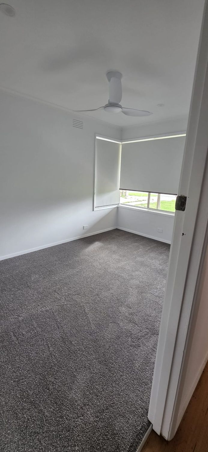 Renovated bedroom with new carpet and a ceiling fan in Thomastown, Melbourne