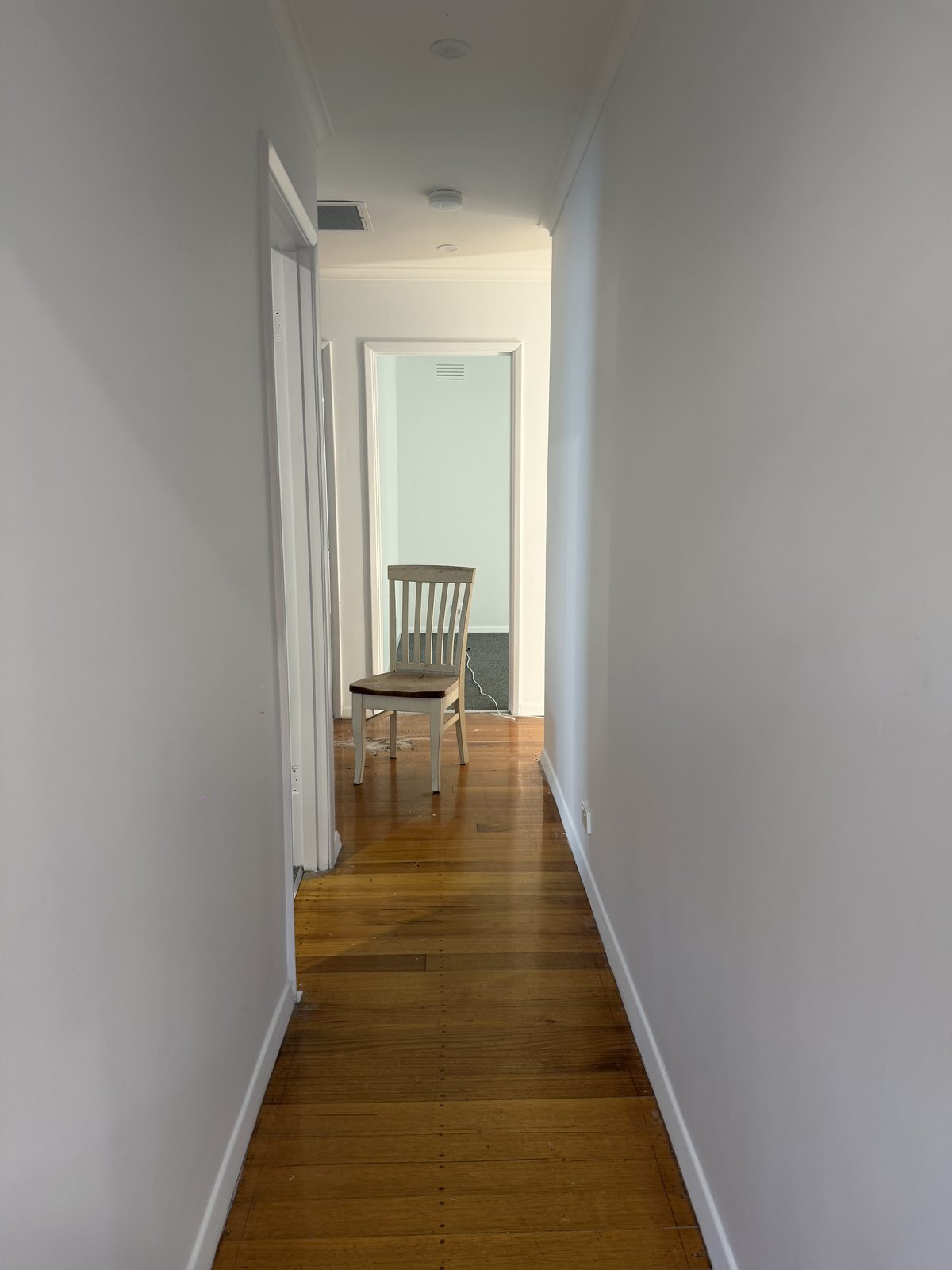 Freshly painted hallway with polished timber floorboards after renovation in Thomastown
