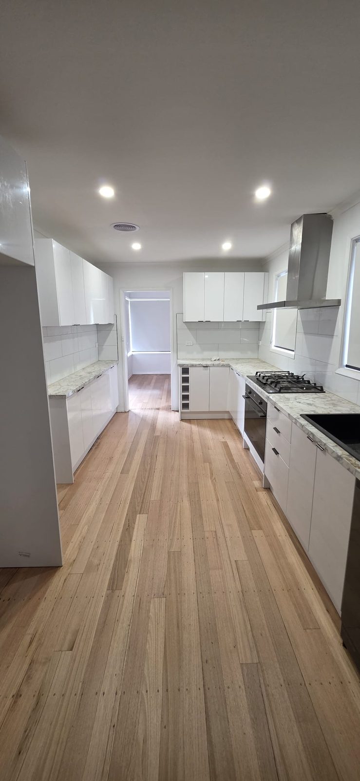 Galley kitchen after renovation with sanded and polished timber floors in Thomastown, Melbourne