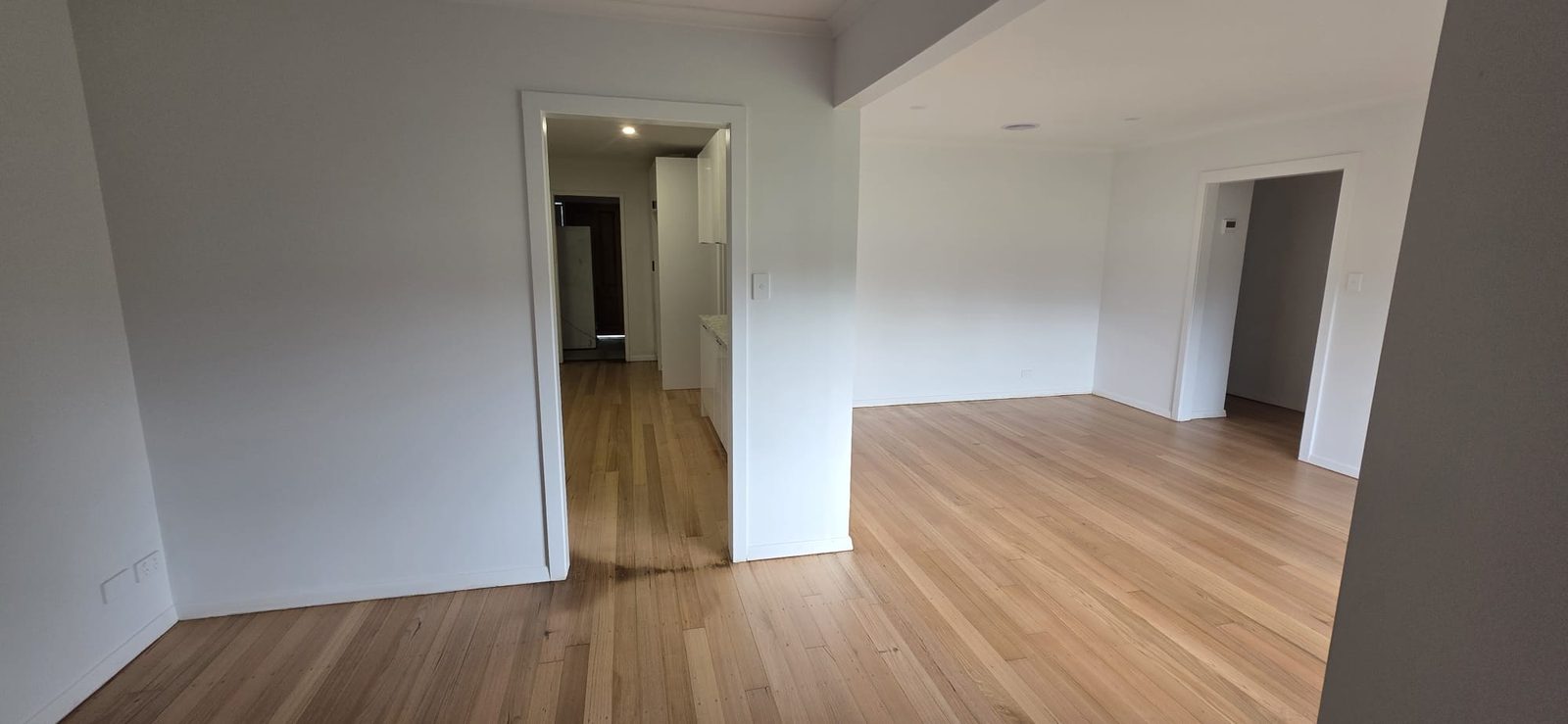 Freshly painted open living area with restored timber floors after renovation in Thomastown