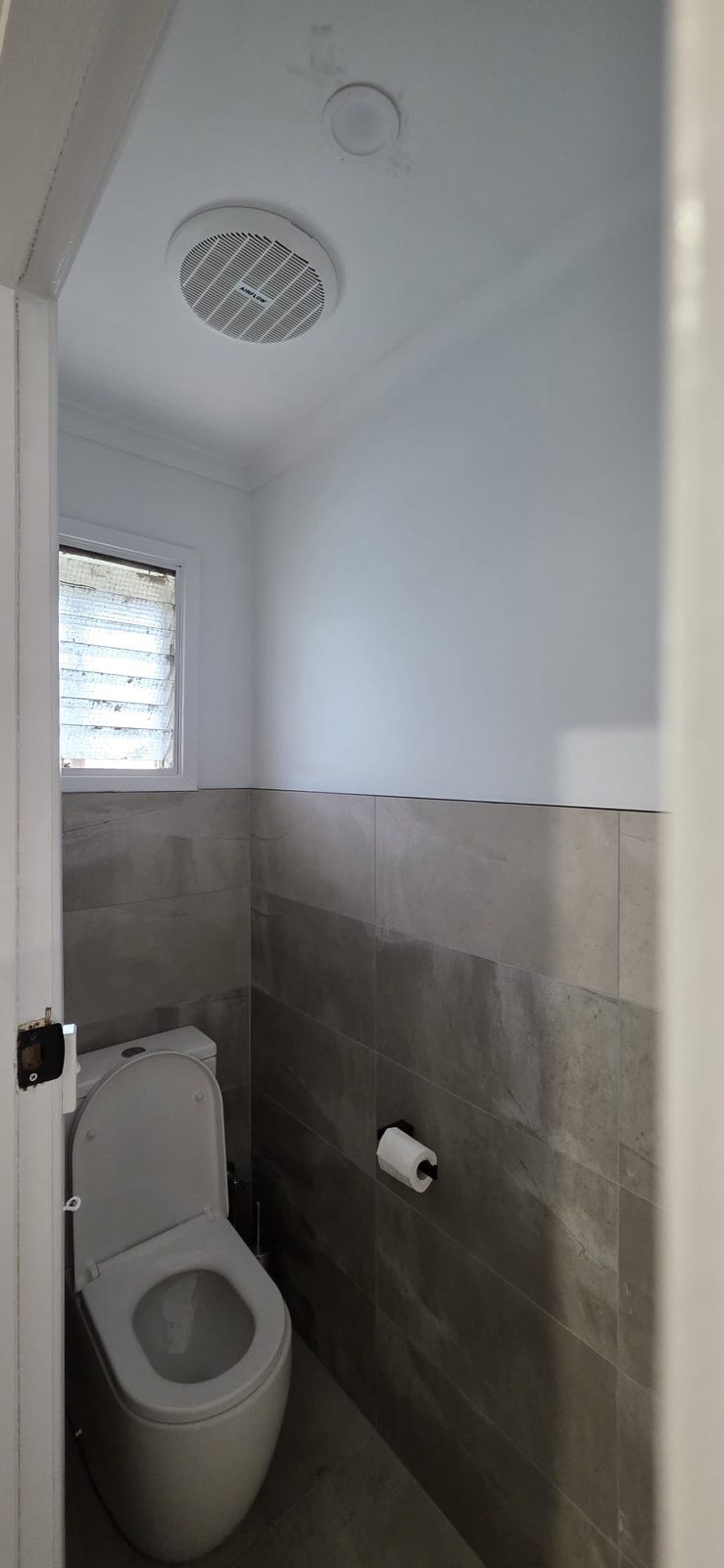 Renovated separate toilet with tiled walls after the Thomastown home renovation